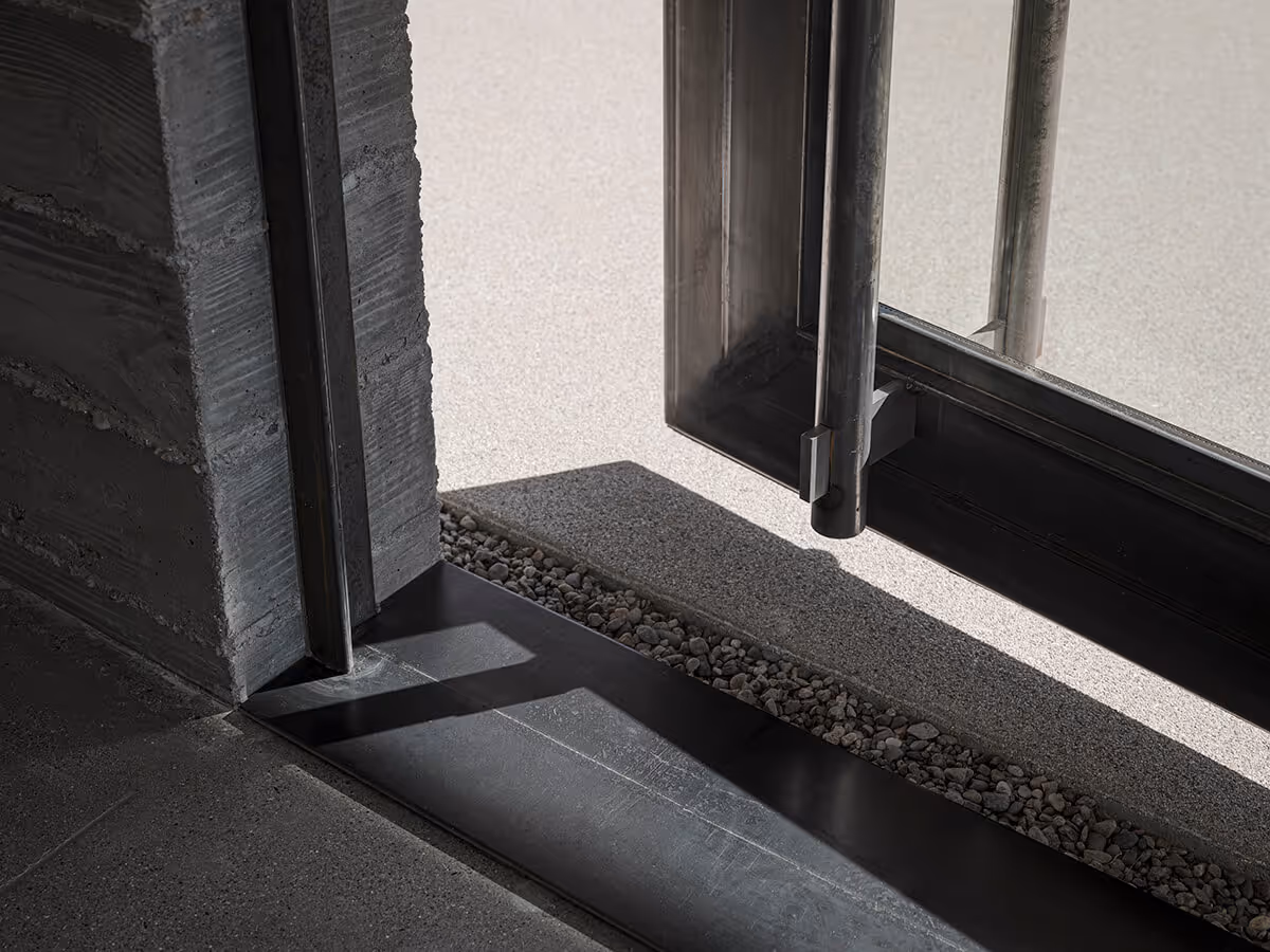 Huge steel and glass pivot door detail on a casita in Phoenix by The Ranch Mine