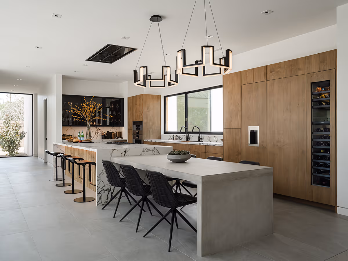 indoor outdoor kitchen with built in concrete table at modern gable house in Paradise Valley Arizona by The Ranch Mine