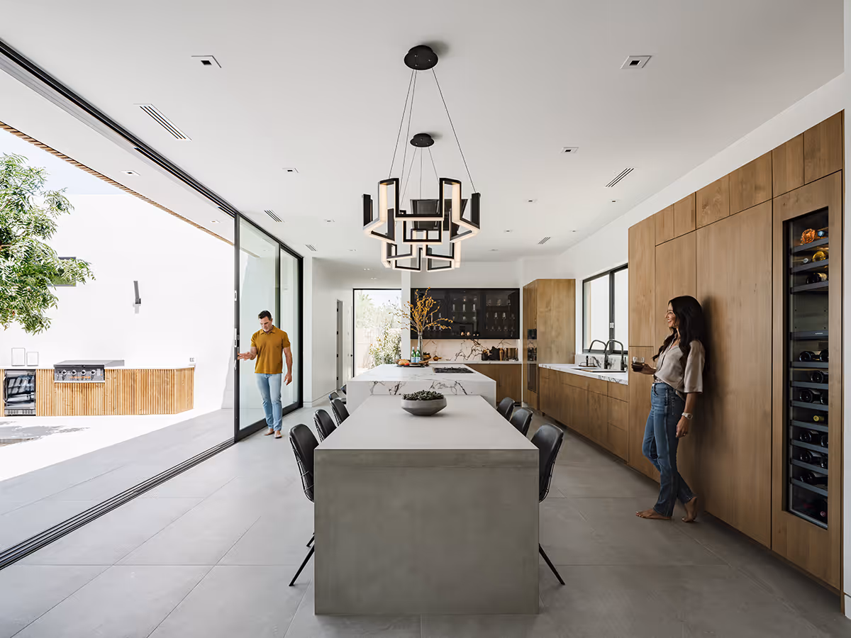 indoor outdoor kitchen with built in concrete table at modern gable house in Paradise Valley Arizona by The Ranch Mine