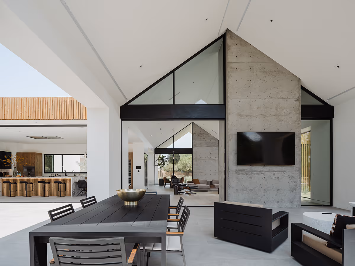 indoor outdoor living with concrete fireplace at modern gable house in Paradise Valley Arizona by The Ranch Mine