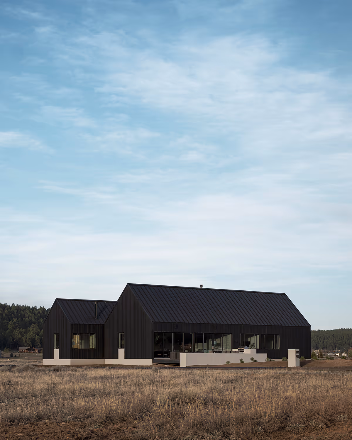 Modern Scandinavian black exterior house with gabled roofs in Flagstaff, Arizona by The Ranch Mine