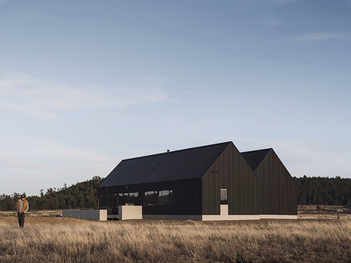 Modern Scandinavian black exterior house with gabled roofs in Flagstaff, Arizona by The Ranch Mine