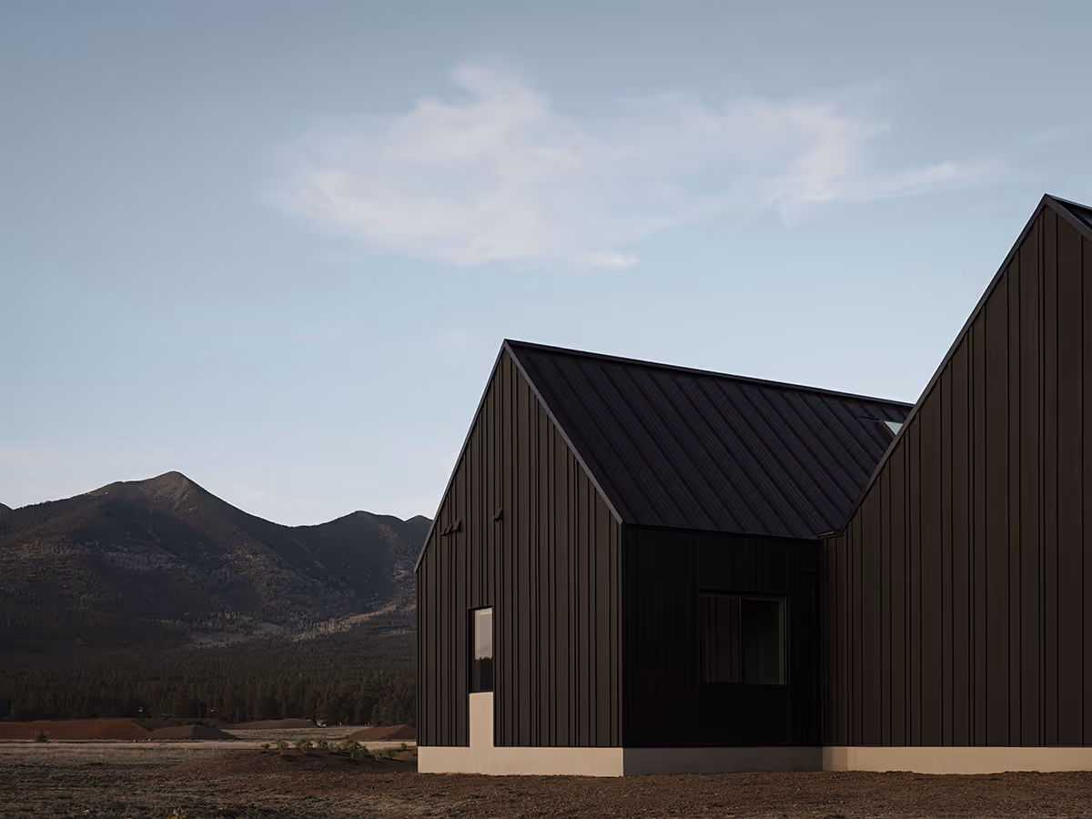 Modern Scandinavian black exterior house with gabled roofs in Flagstaff, Arizona by The Ranch Mine