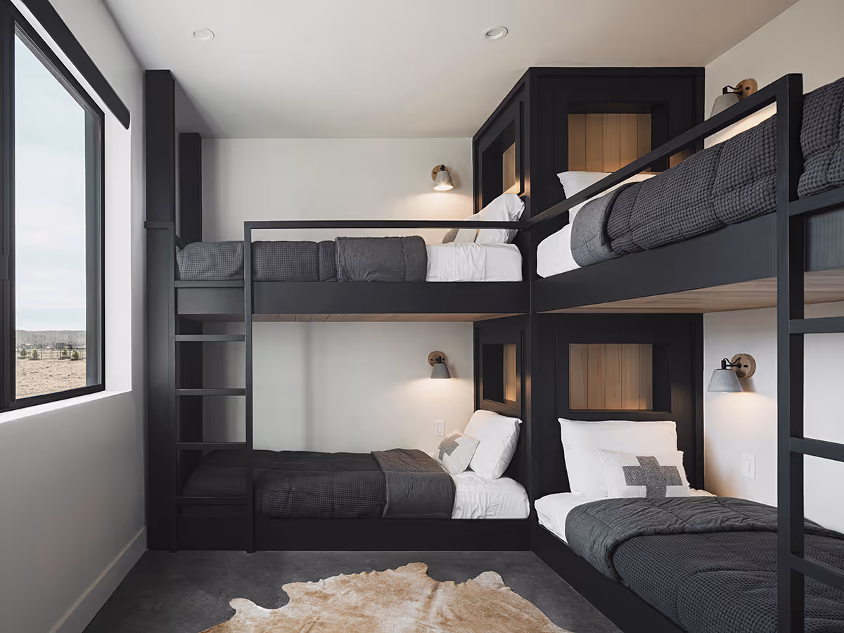 Bunk bed room at a modern Scandinavian black exterior house with gabled roofs in Flagstaff, Arizona by The Ranch Mine