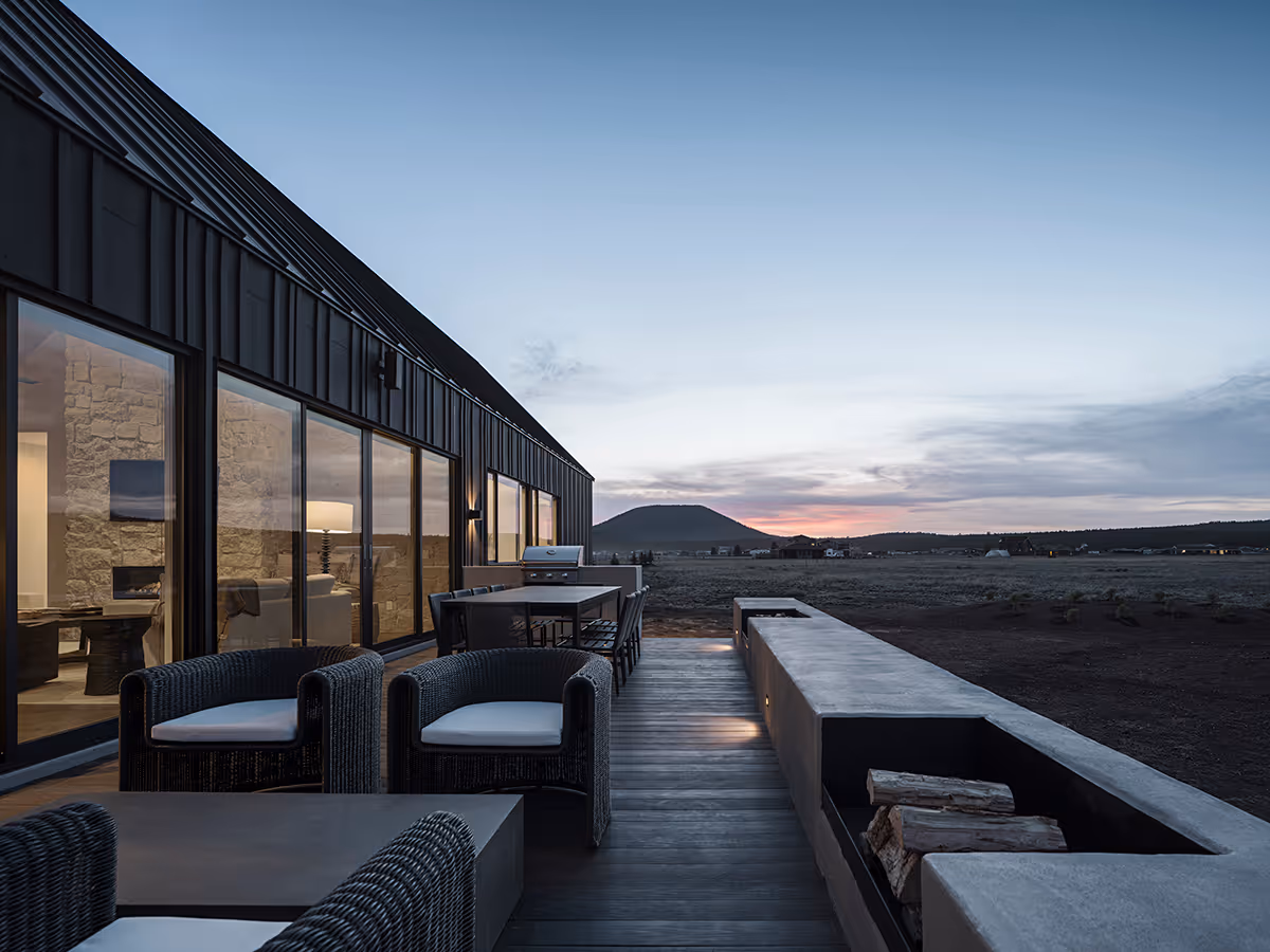Modern Scandinavian black exterior house with gabled roofs in Flagstaff, Arizona by The Ranch Mine at night