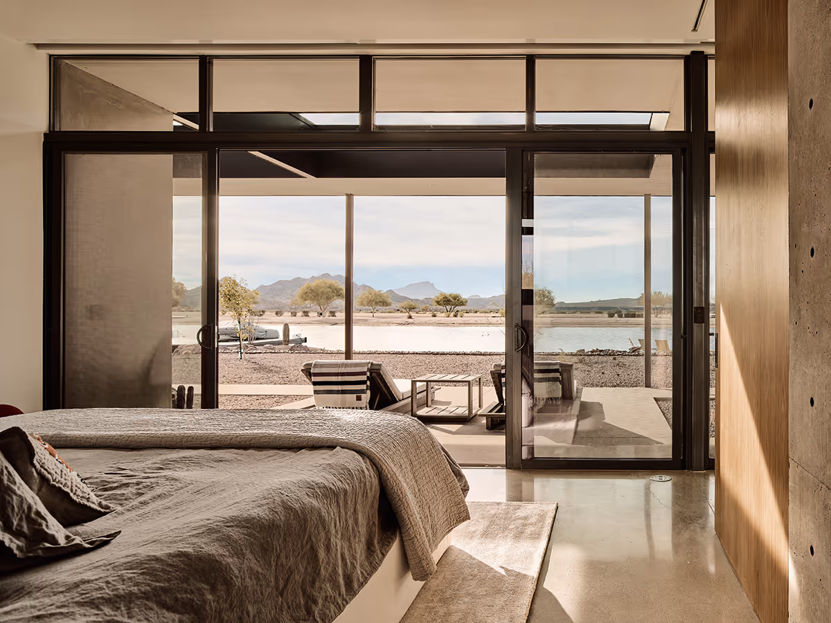 bedroom with view of water ski lake at a desert modern house in Arizona by The Ranch Mine