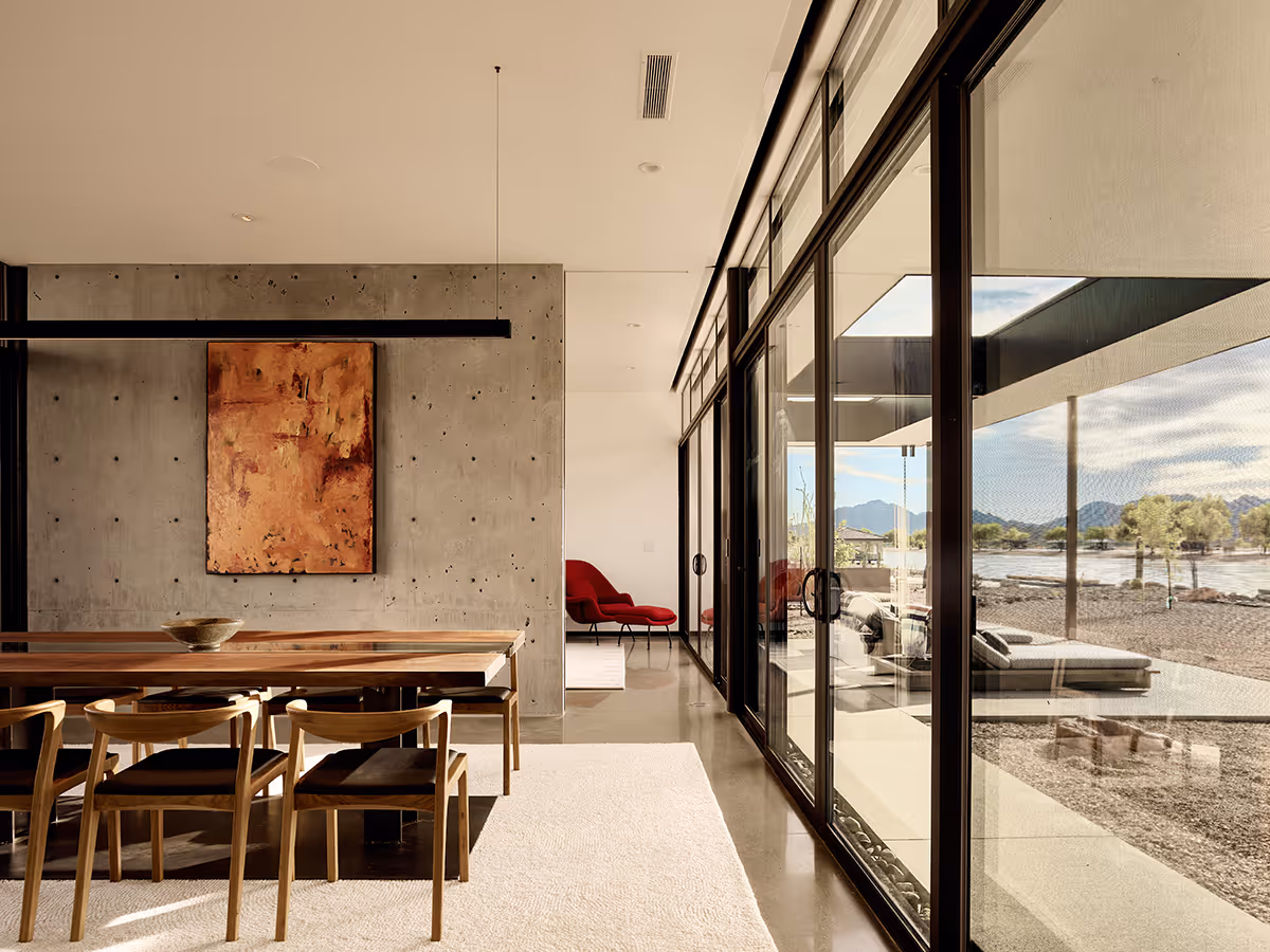 dining room with cast in place concrete wall at a desert modern house in Arizona by The Ranch Mine