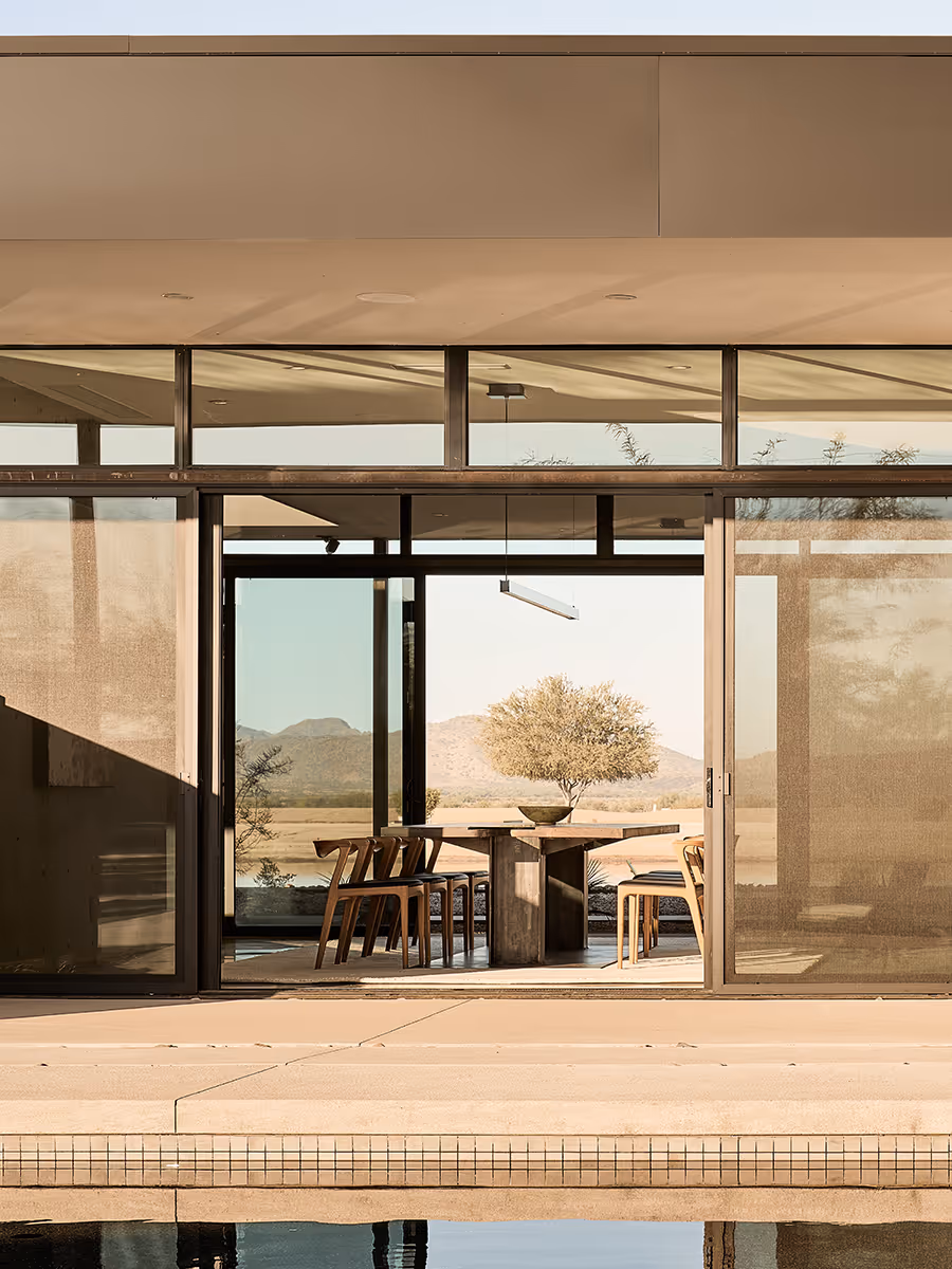 indoor outdoor dining room at a desert modern house in Arizona by The Ranch Mine