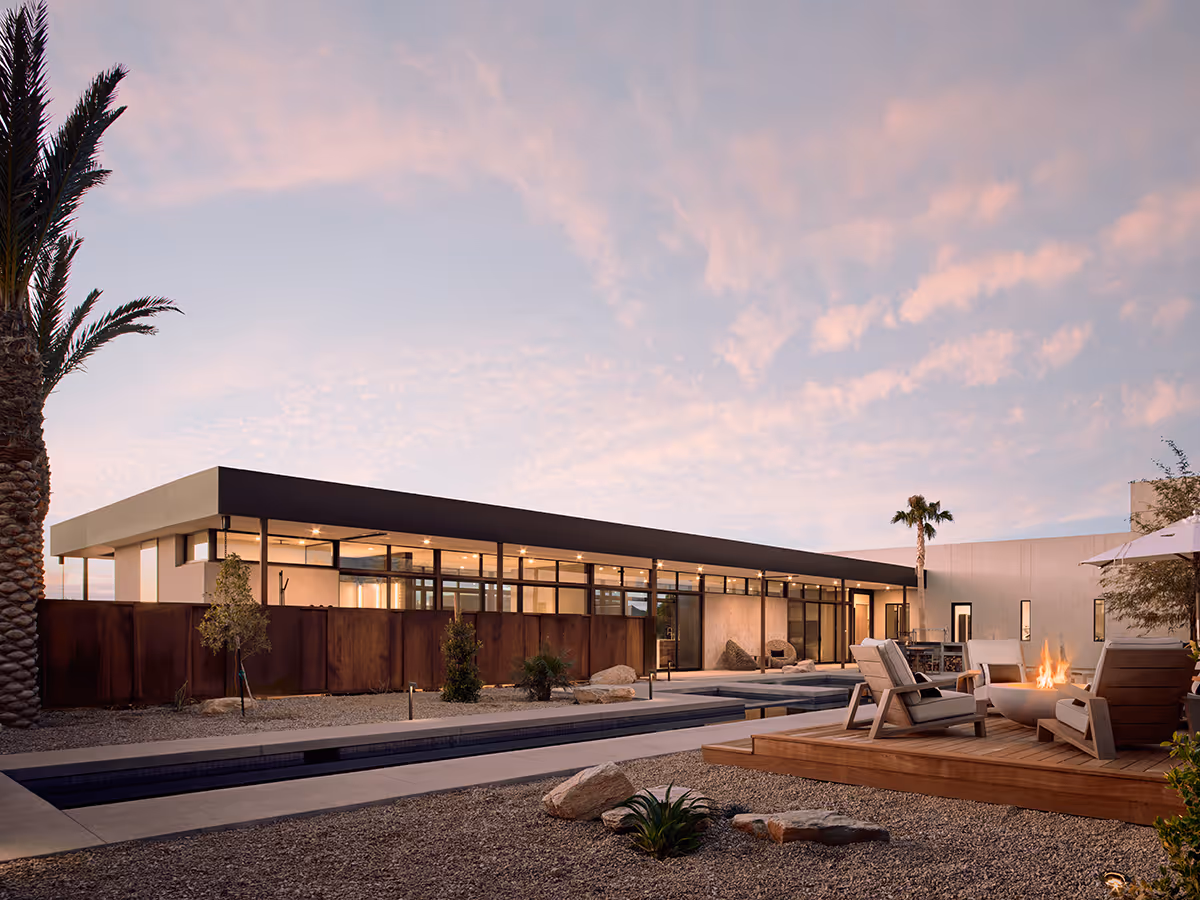 lap pool and fire pit at dusk at a desert modern house in Arizona by The Ranch Mine