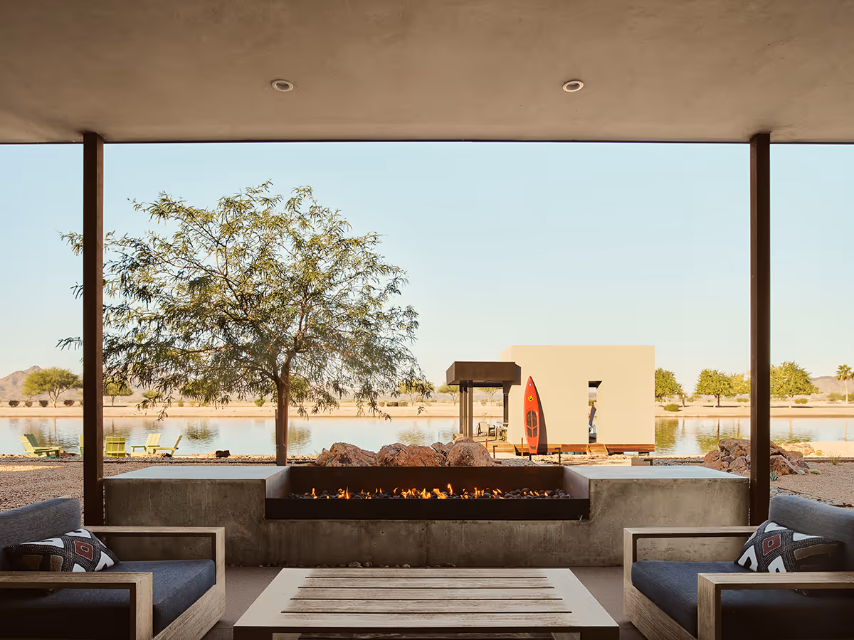 fire pit and view of boat house at a desert modern house on a water ski lake in Arizona by The Ranch Mine