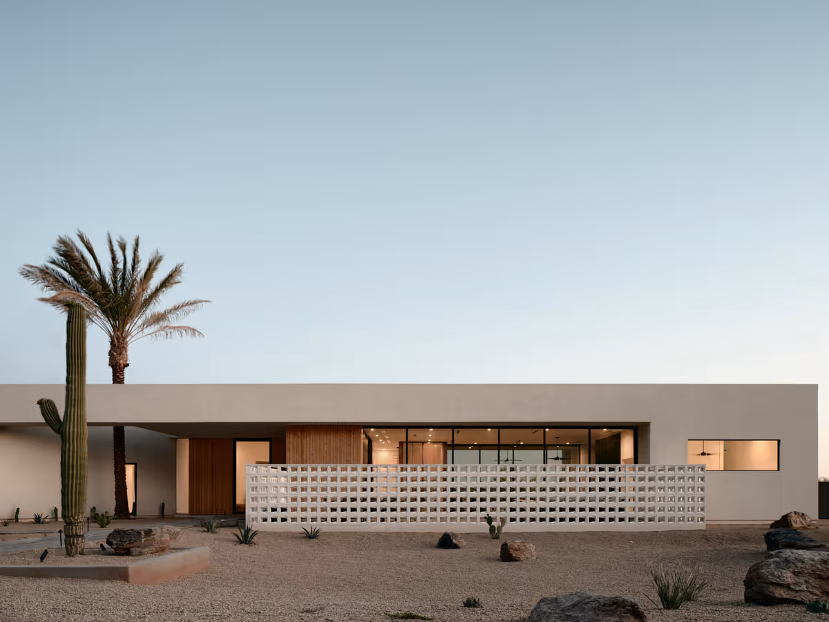 modern house with breeze block wall and date palm tree through roof aperture by The Ranch Mine