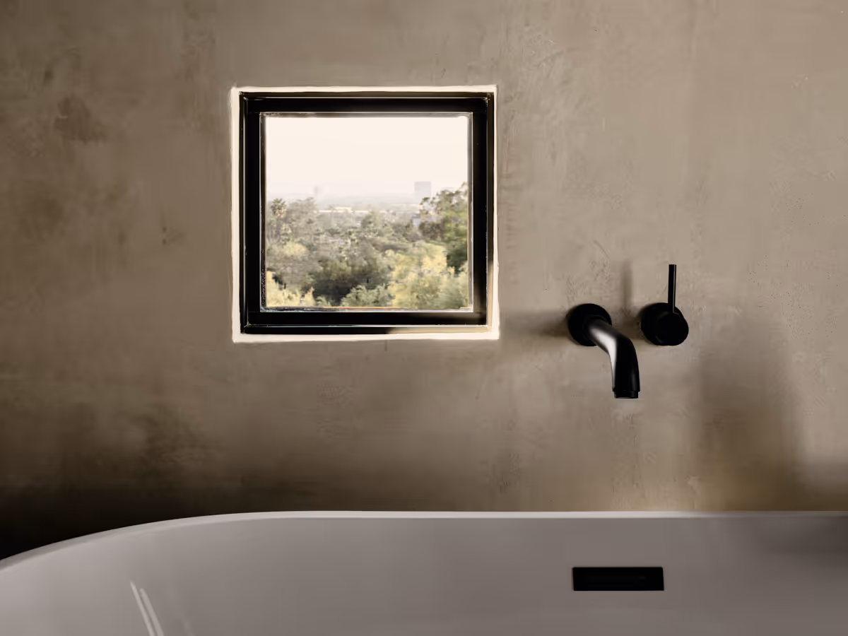tub with small window on plastered wall by The Ranch Mine