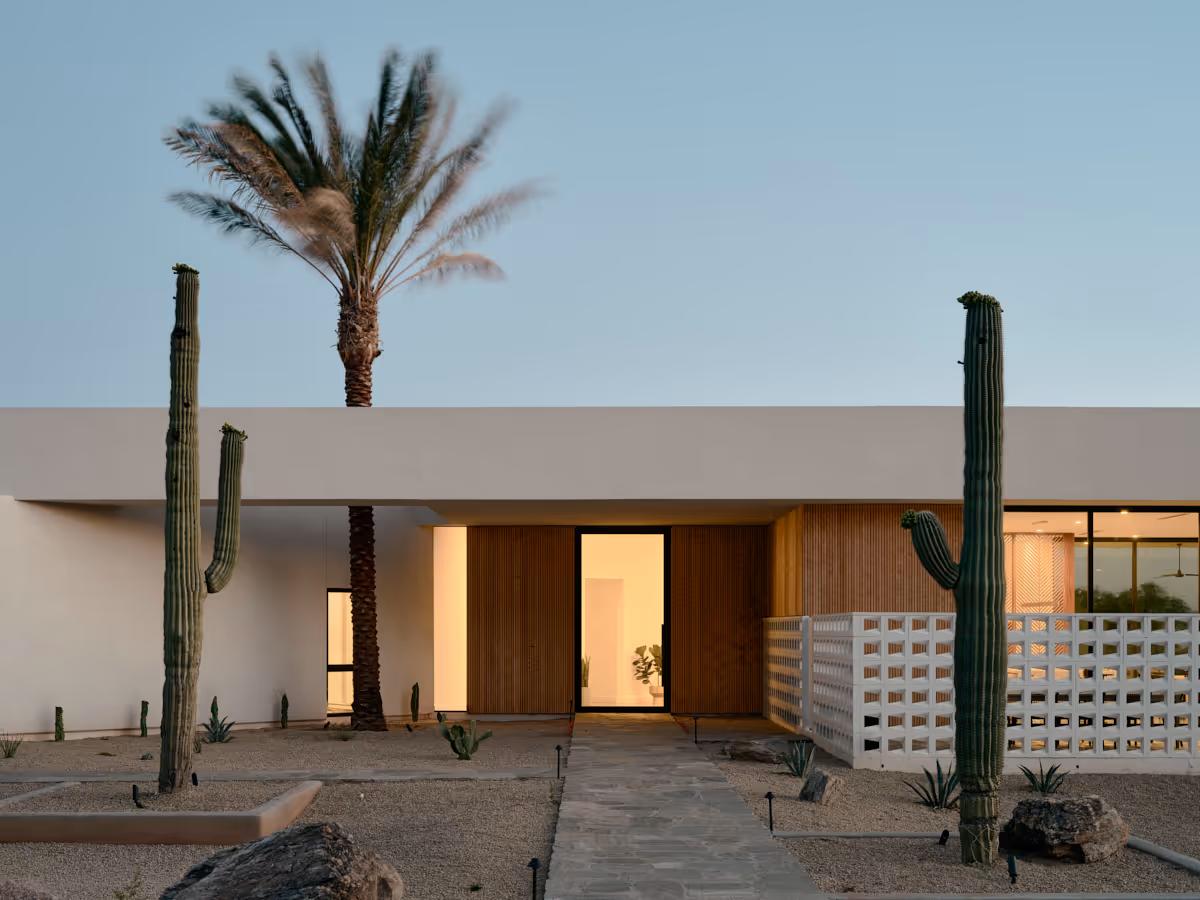 modern house with breeze block wall and date palm tree through roof aperture by The Ranch Mine