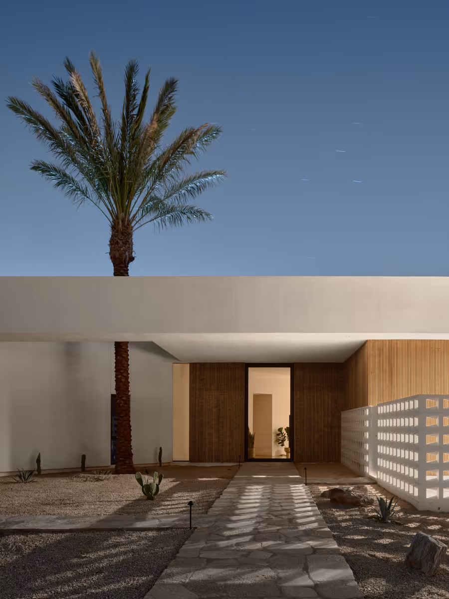 modern house with breeze block wall and date palm tree through roof aperture by The Ranch Mine