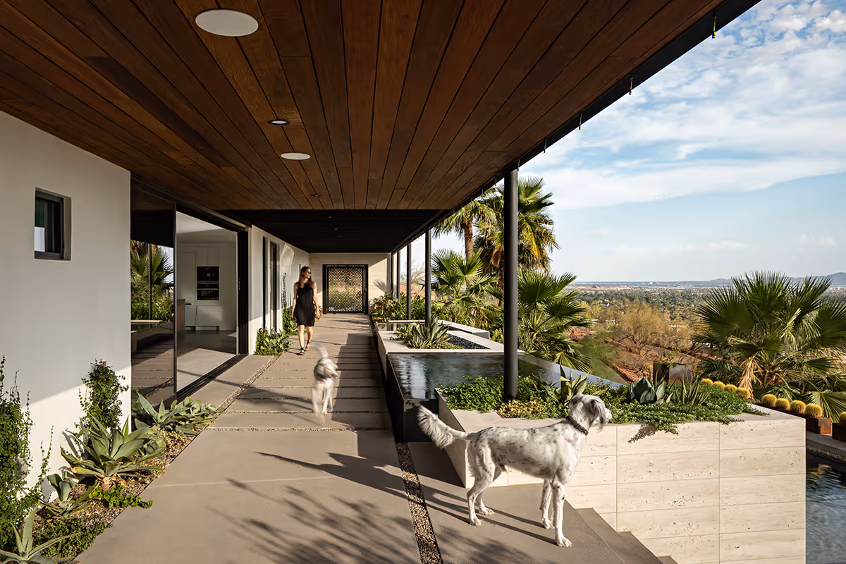 Covered walkway with a view of Phoenix at a home renovation and addition transforming a Spanish Colonial Revival house into a modern mountainside home in Phoenix by The Ranch Mine