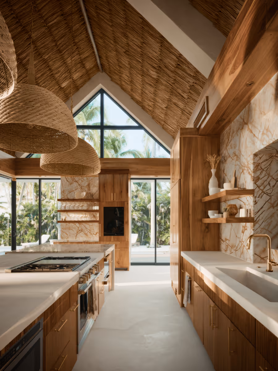 Kitchen with thatched ceiling and custom sam wood cabinetry at a tropical modern house in Belize by The Ranch Mine