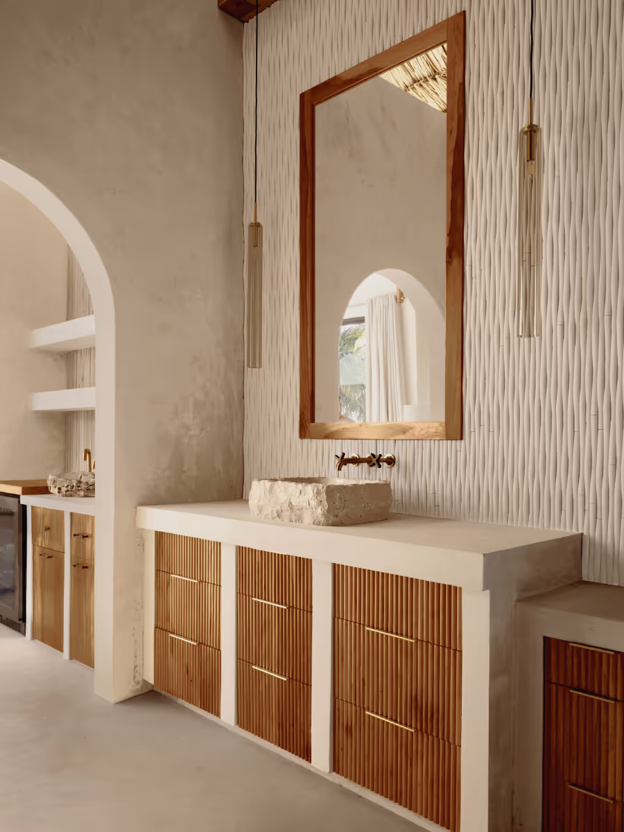 Concrete counter with wood cabinets at a tropical modern house in Belize by The Ranch Mine