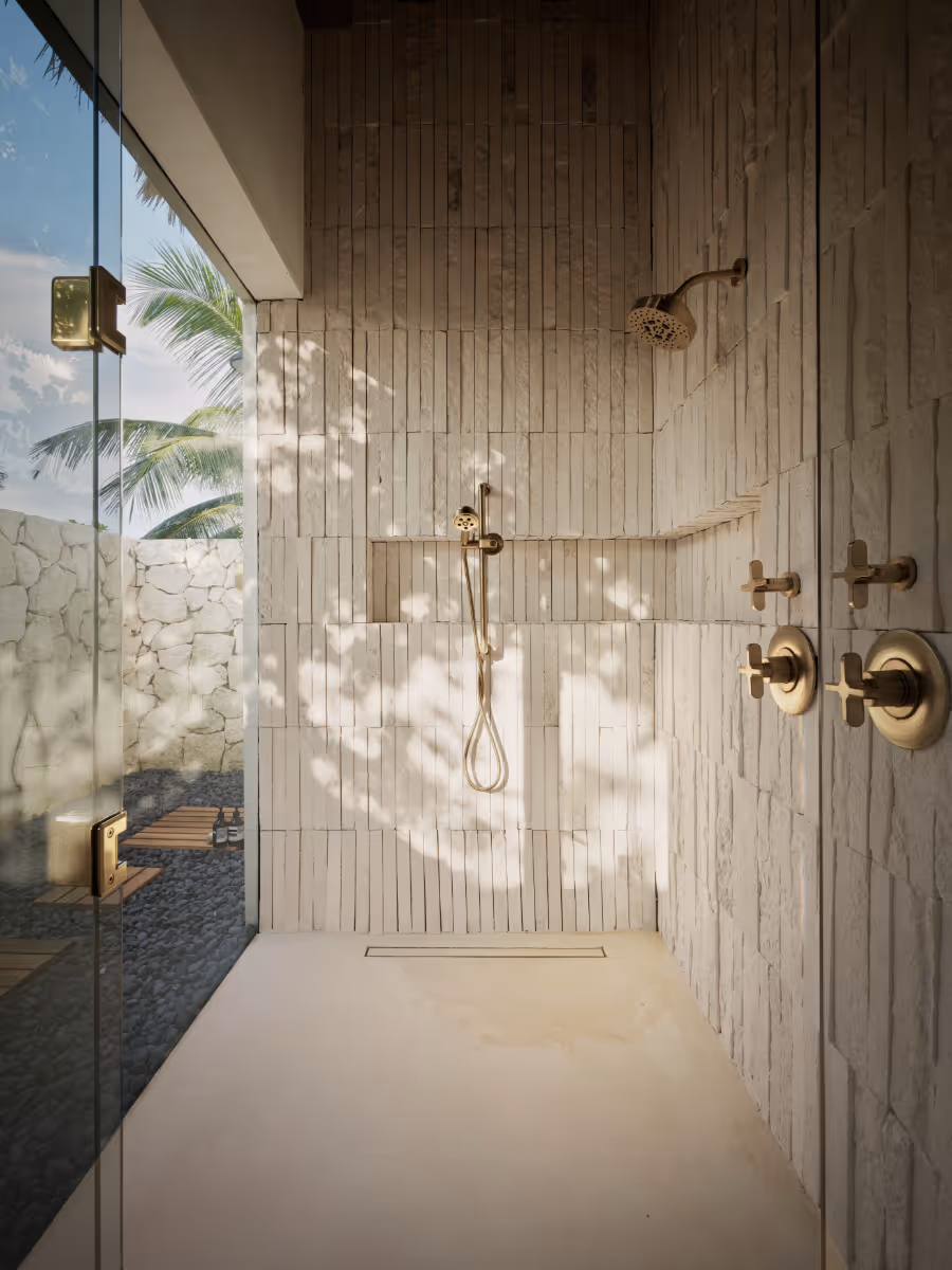 Indoor outdoor shower at a tropical modern house in Belize by The Ranch Mine