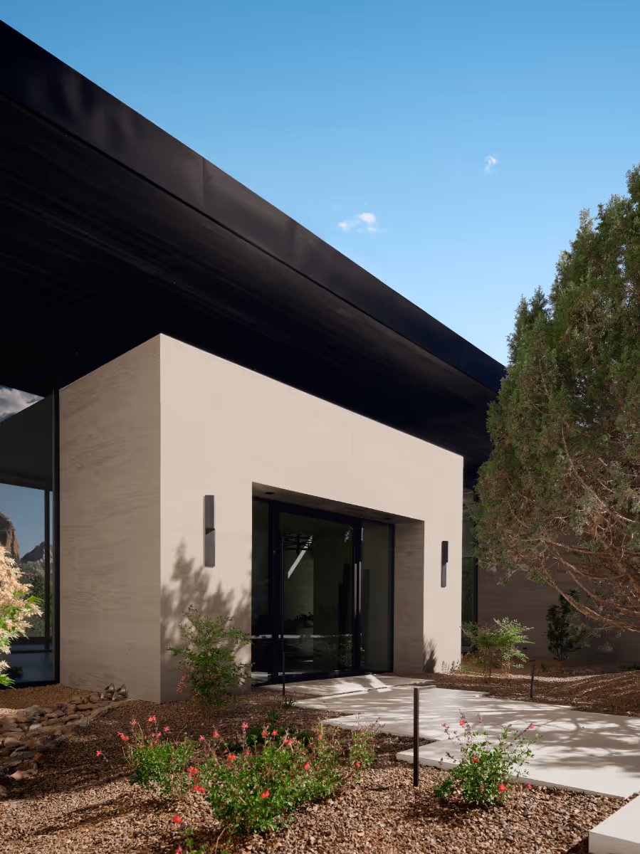 Limestone entry full-height glass to a modern new build home in Sedona by The Ranch Mine