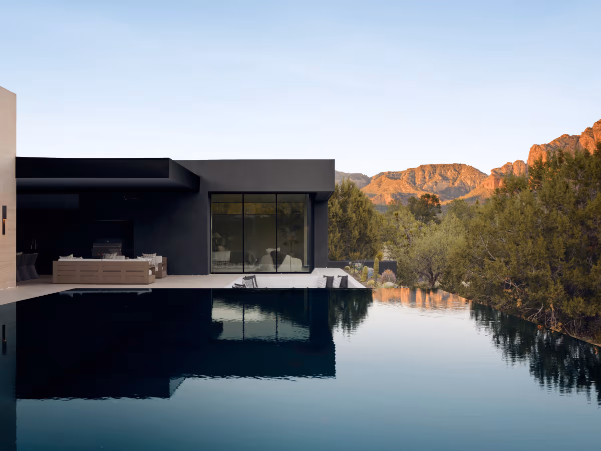 Negative-edge pool reflecting the sky in modern new build home in Seven Canyons in Sedona by The Ranch Mine