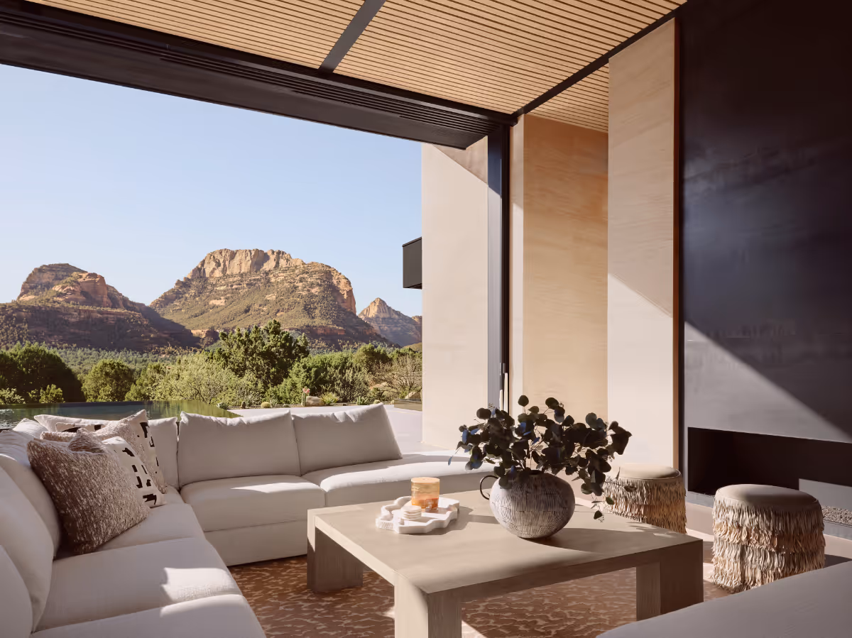 Living room with pocketing glass doors with custom wood slat ceiling in new build home in Seven Canyons in Sedona by The Ranch Mine