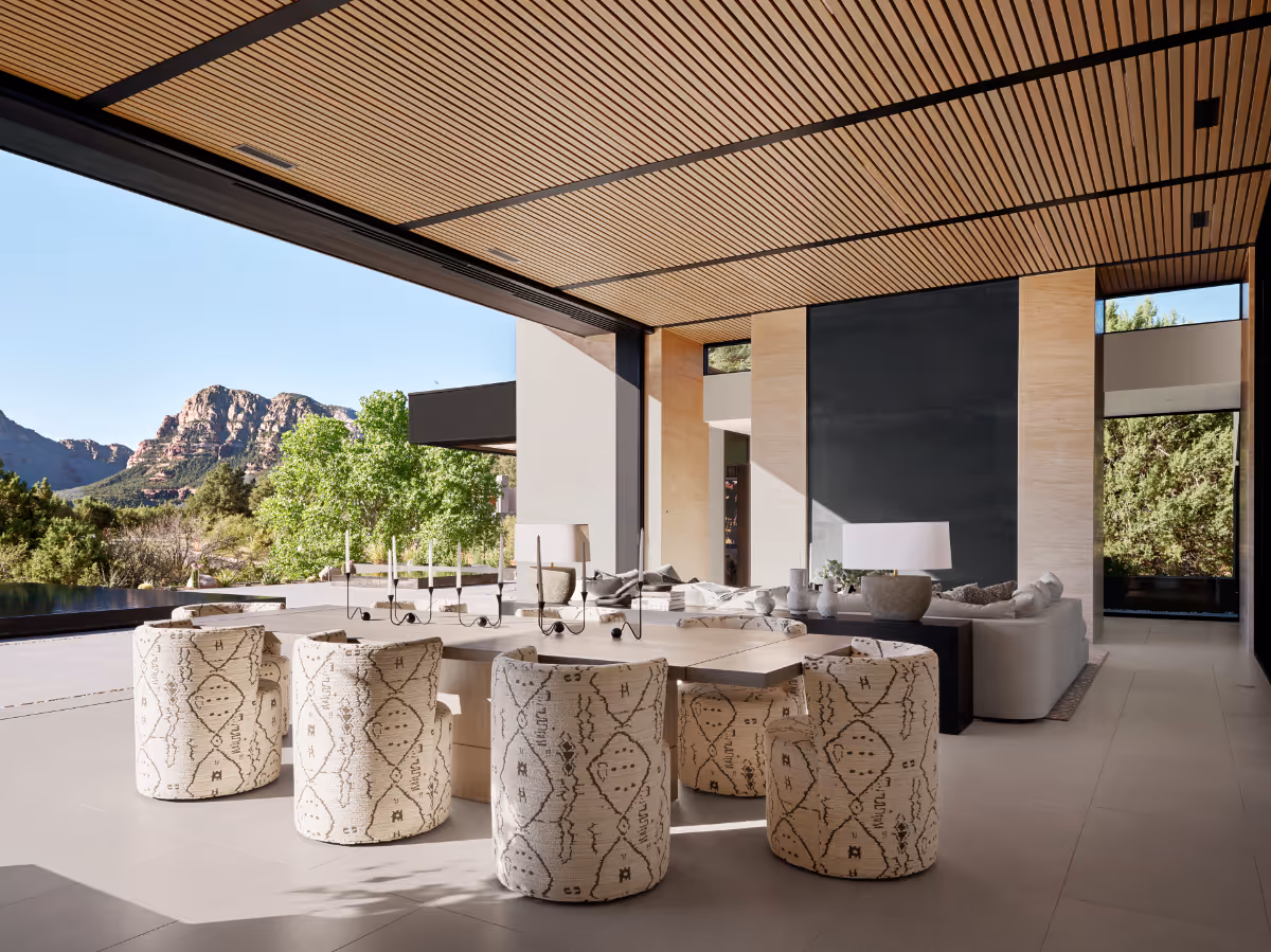 Great room with pocketing glass doors with custom wood slat ceiling in new build home in Seven Canyons in Sedona by The Ranch Mine