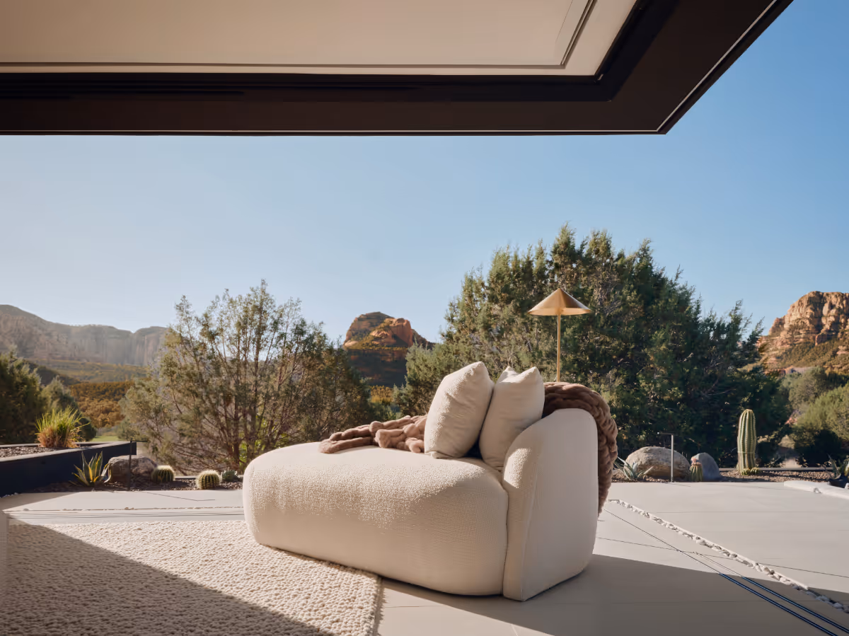 Corner pocketing glass doors open the primary bedroom up to the courtyard in Seven Canyons in Sedona by The Ranch Mine