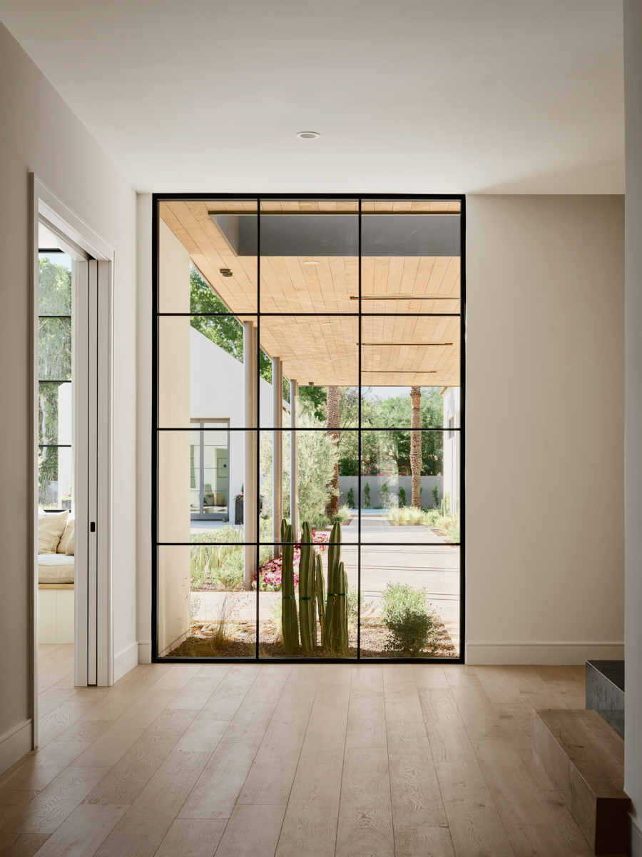 Hallway with controlled apertures, light and shadow defining movement, by The Ranch Mine