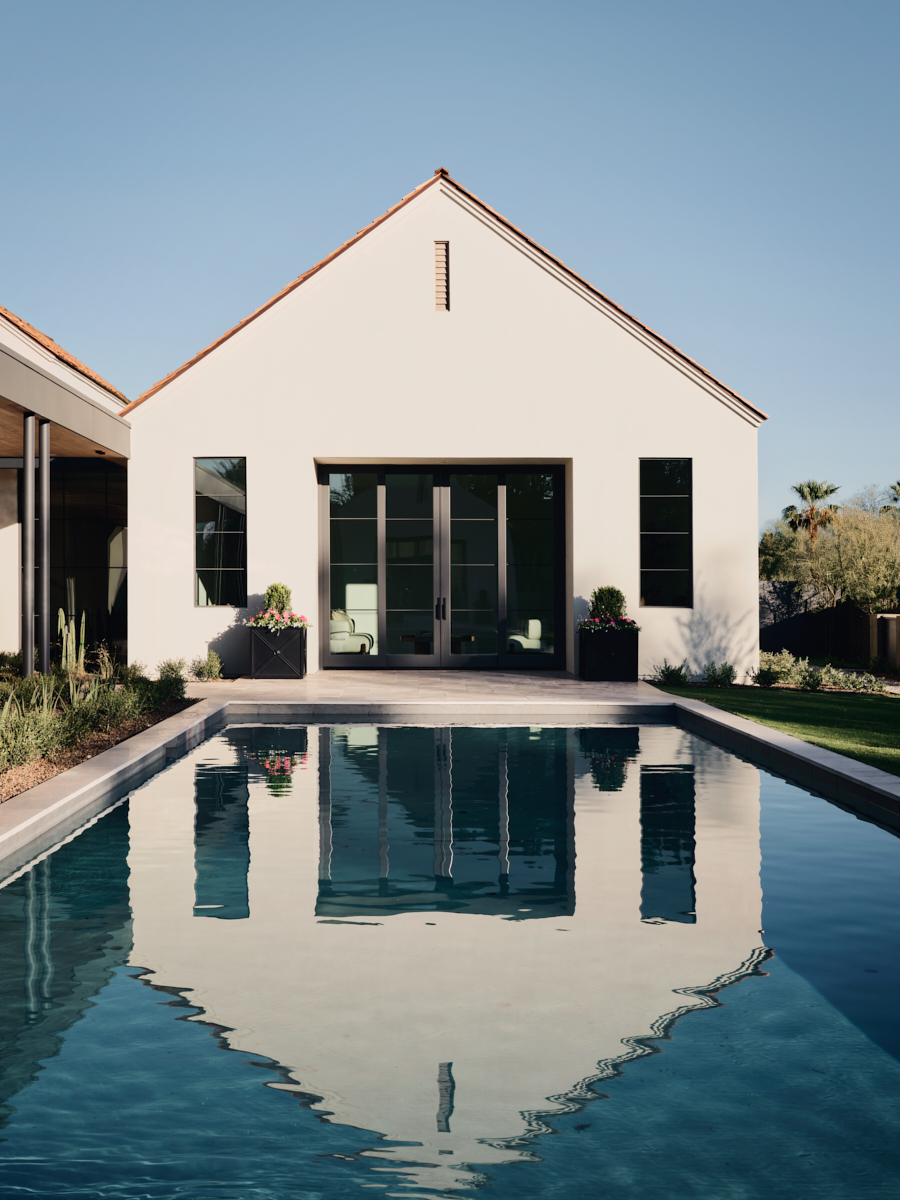 Gable roof reflecting in linear pool by The Ranch Mine