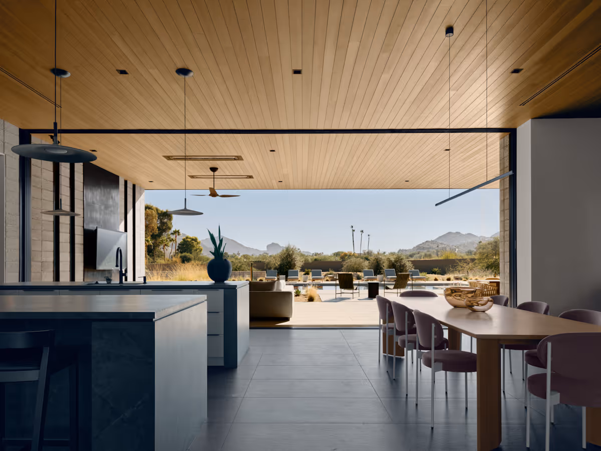 kitchen and dining opening up to outdoor living  at Full Circle, a multigenerational new build compound in Paradise Valley, Arizona by The Ranch Mine