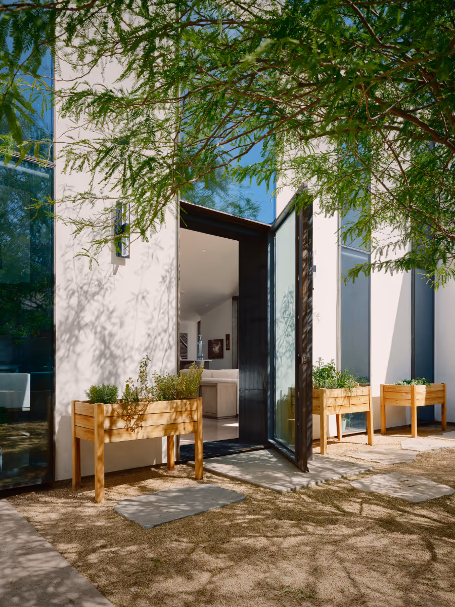 desert courtyard house with raised planters for an artist