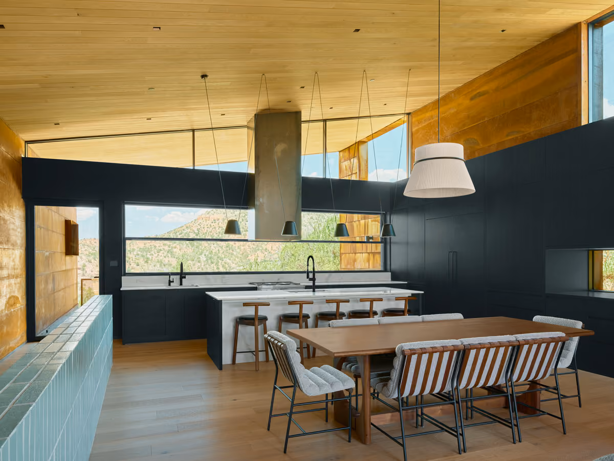 Open kitchen and dining room with clerestory glass and green canyon views above the sink