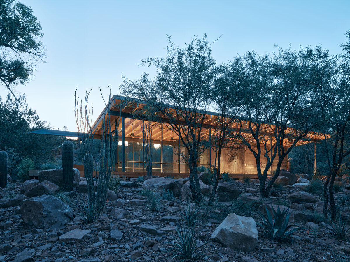 night view of modern pavilion in the woods by a creek in Sedona