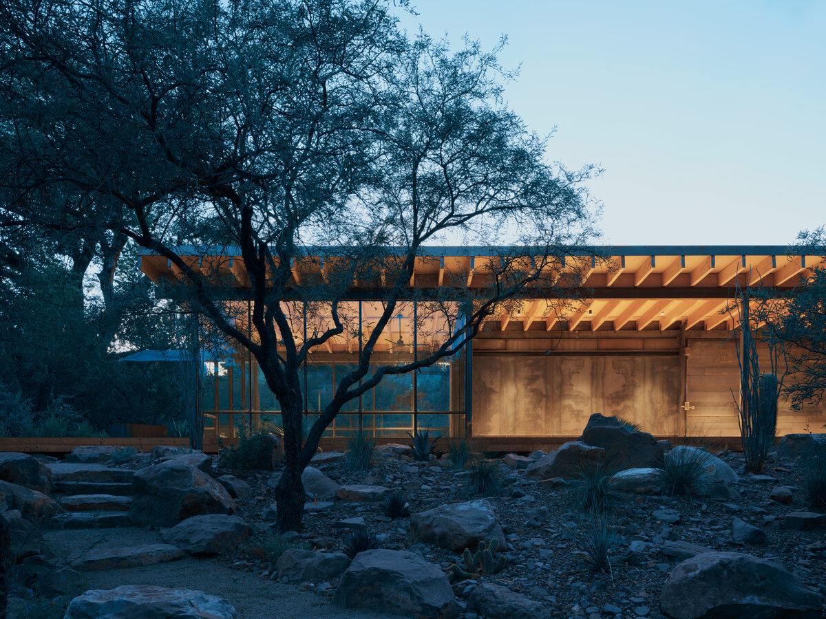 night view of modern pavilion in the woods by a creek in Sedona