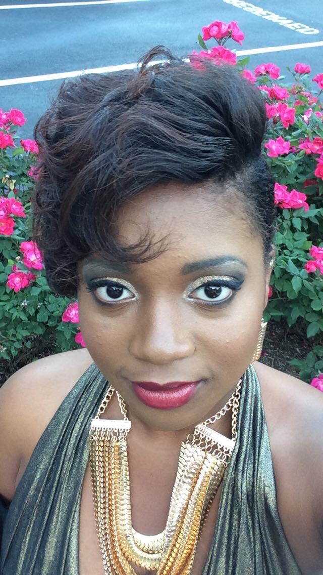 A headshot of myself, the graphic designer, in front of a flowerbed.