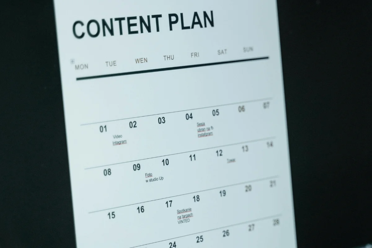 A white calendar labeled "Content Plan" on a black background. It shows a week starting Monday, listing tasks like "Video" and "Photo." The tone is organized.