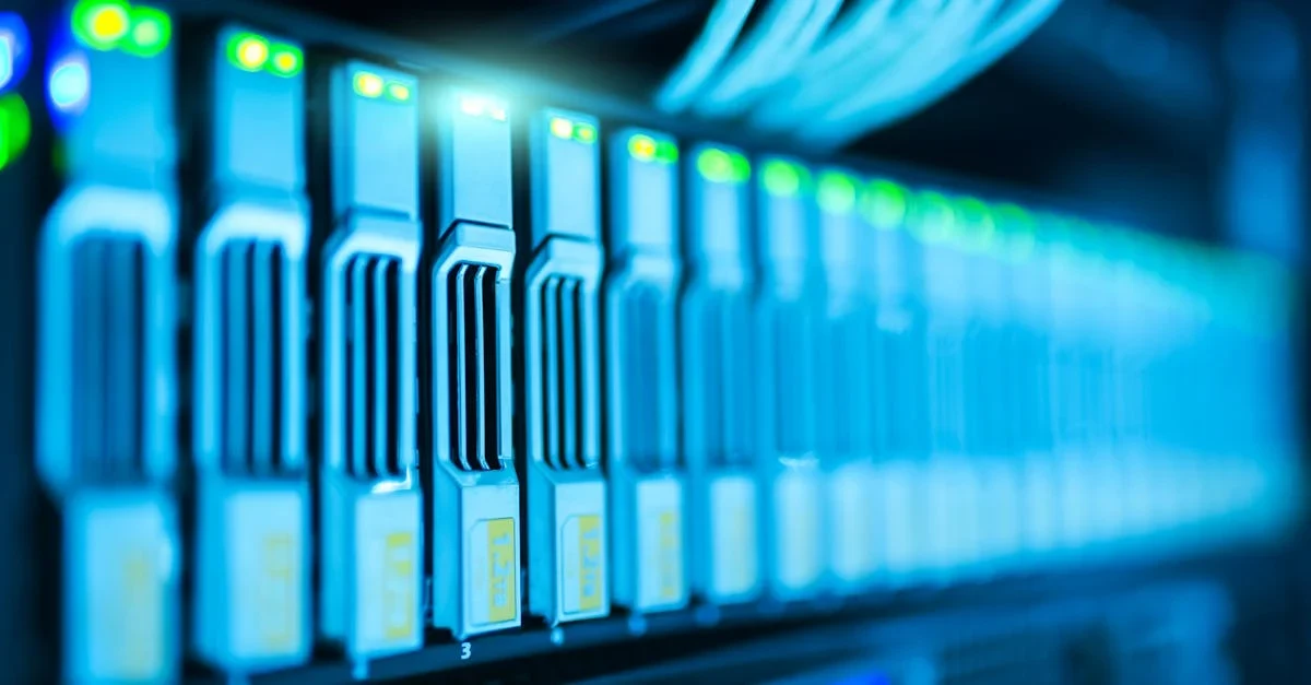 Illuminated blue server racks in data center with glowing lights, sleek design, and futuristic high-tech atmosphere.