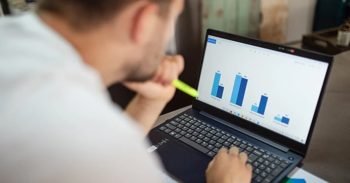 Professional analyzing blue bar charts on laptop screen reviewing enterprise SEO case study performance data.