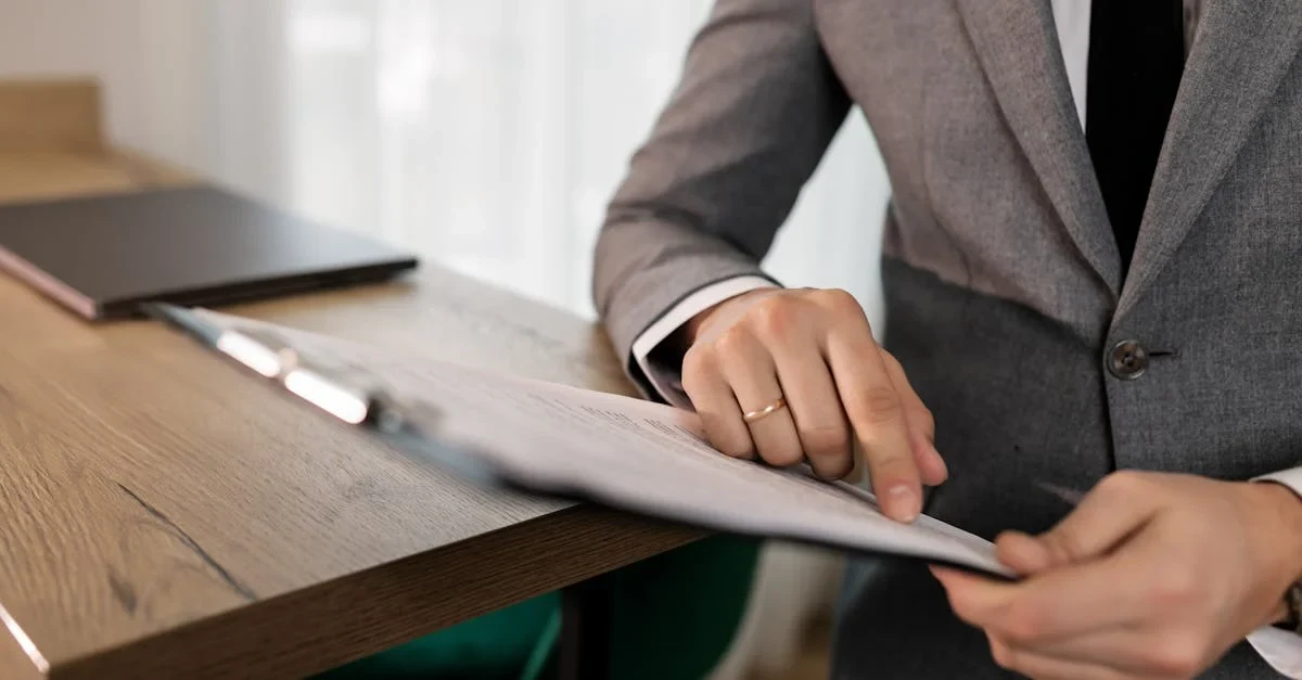 Business professional in gray suit reviewing enterprise SEO packages documents at modern office desk.