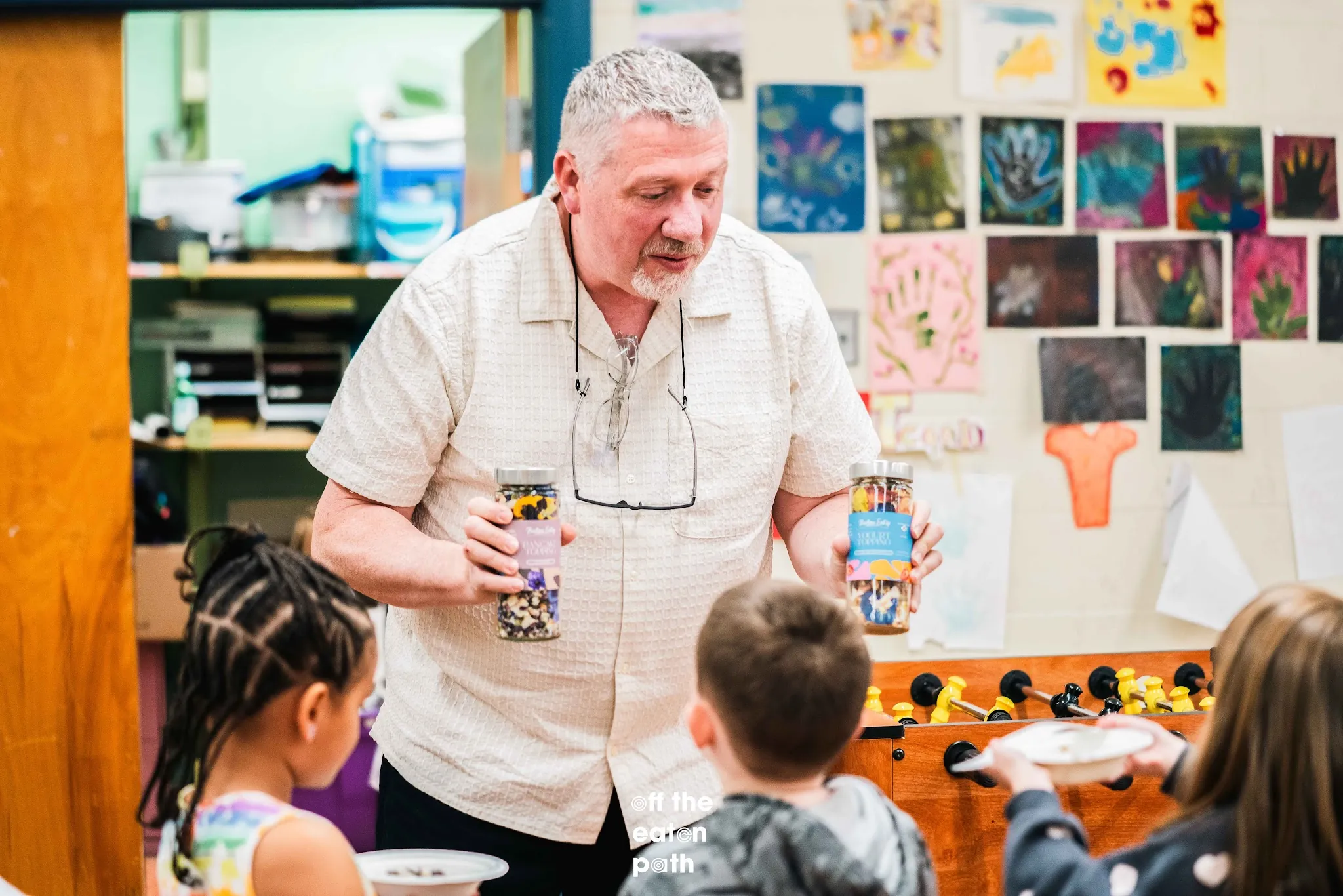 Boutique Eatery co-founder Daren introduces yogurt toppings to students.