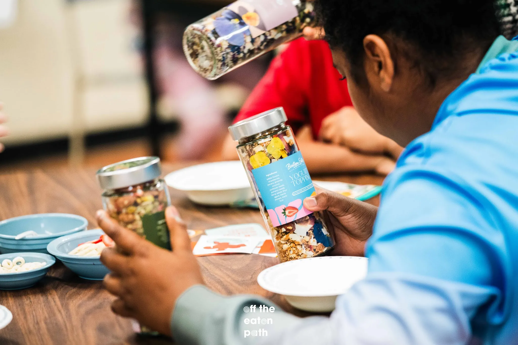 Student holds Boutique Eatery yogurt toppings during the Taste Lab workshop.