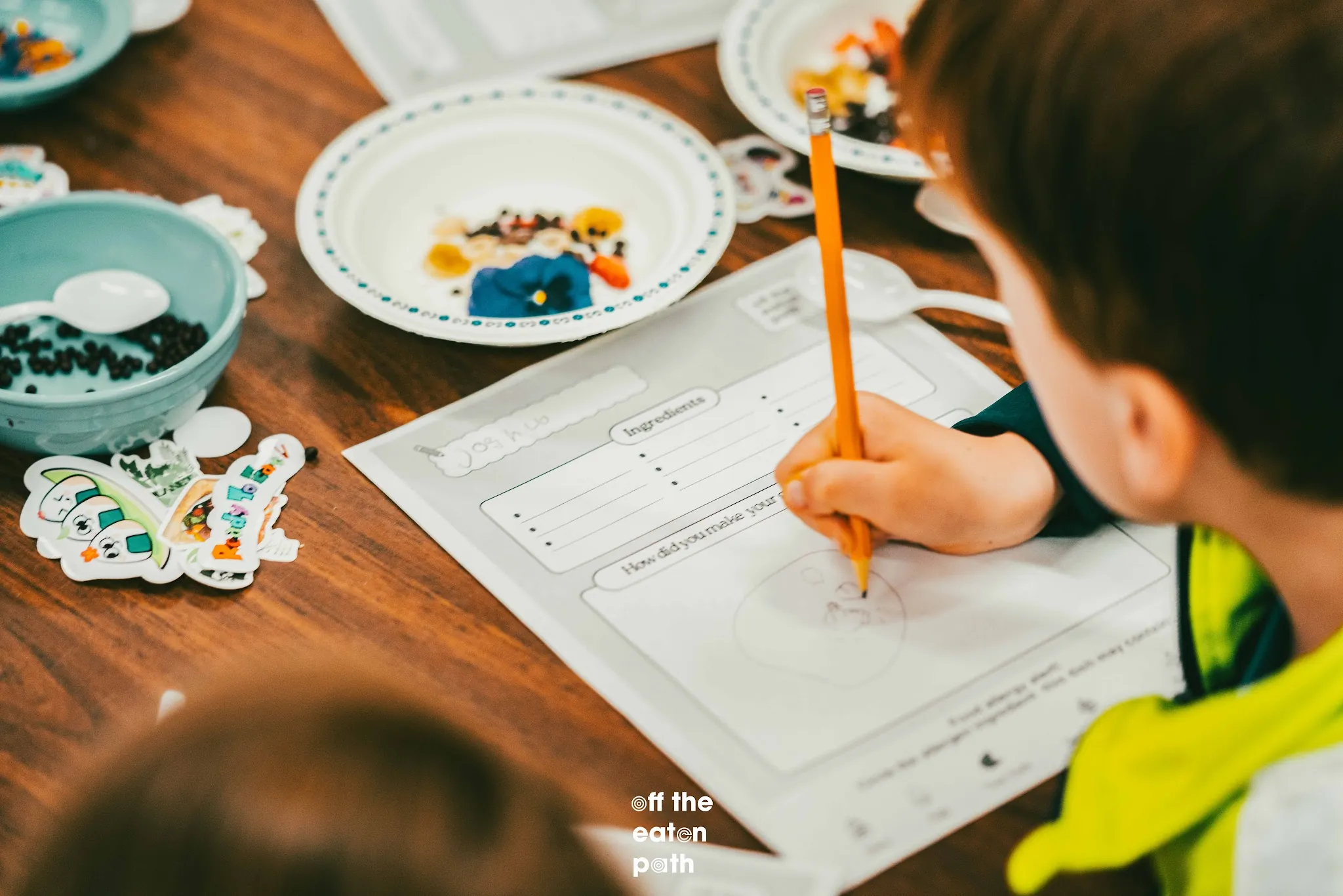 Student records yogurt bowl ingredients and design ideas on a Taste Lab worksheet.