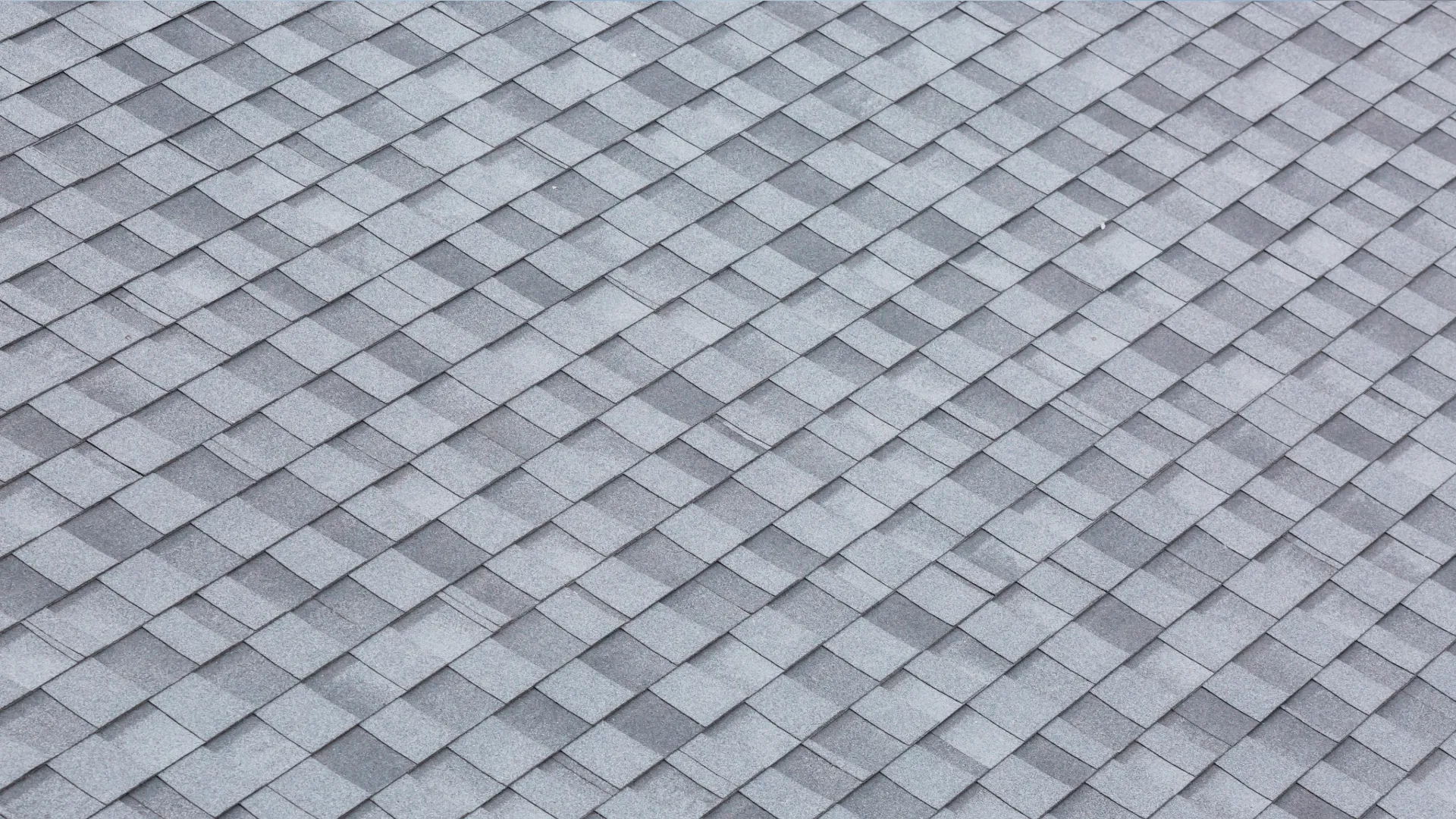 Gray asphalt shingle roof with overlapping pattern, providing durable weather protection.