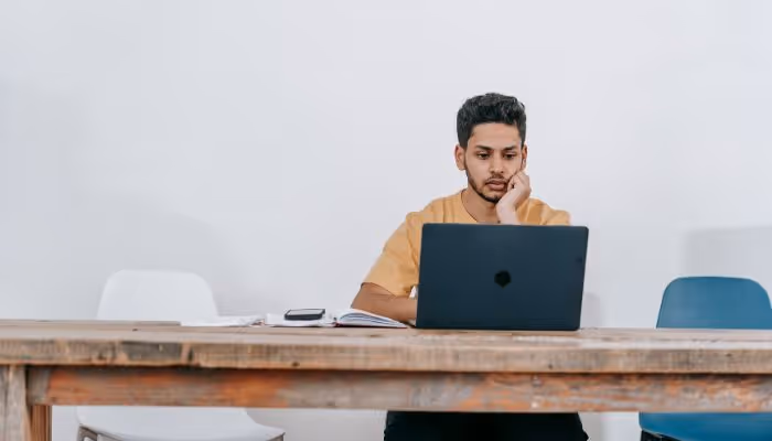 guy at desk searching on a computer