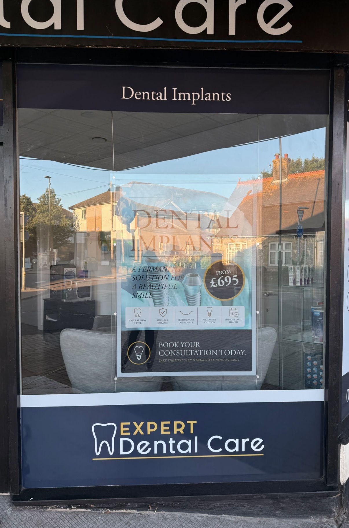 Dental implants window graphics and poster display at Expert Dental Care.