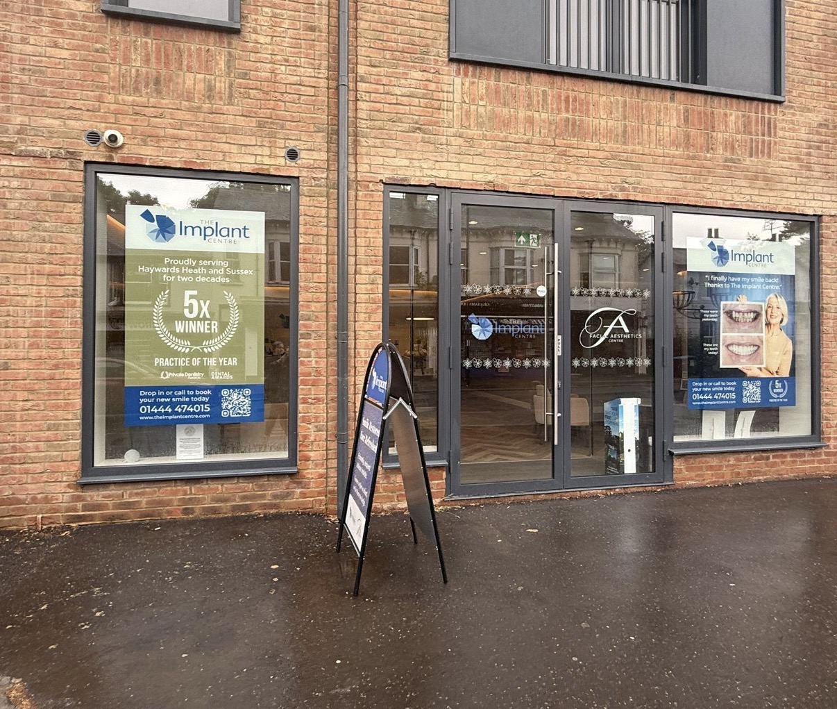 Window posters, frosted door manifestation and A-board at The Implant Centre.