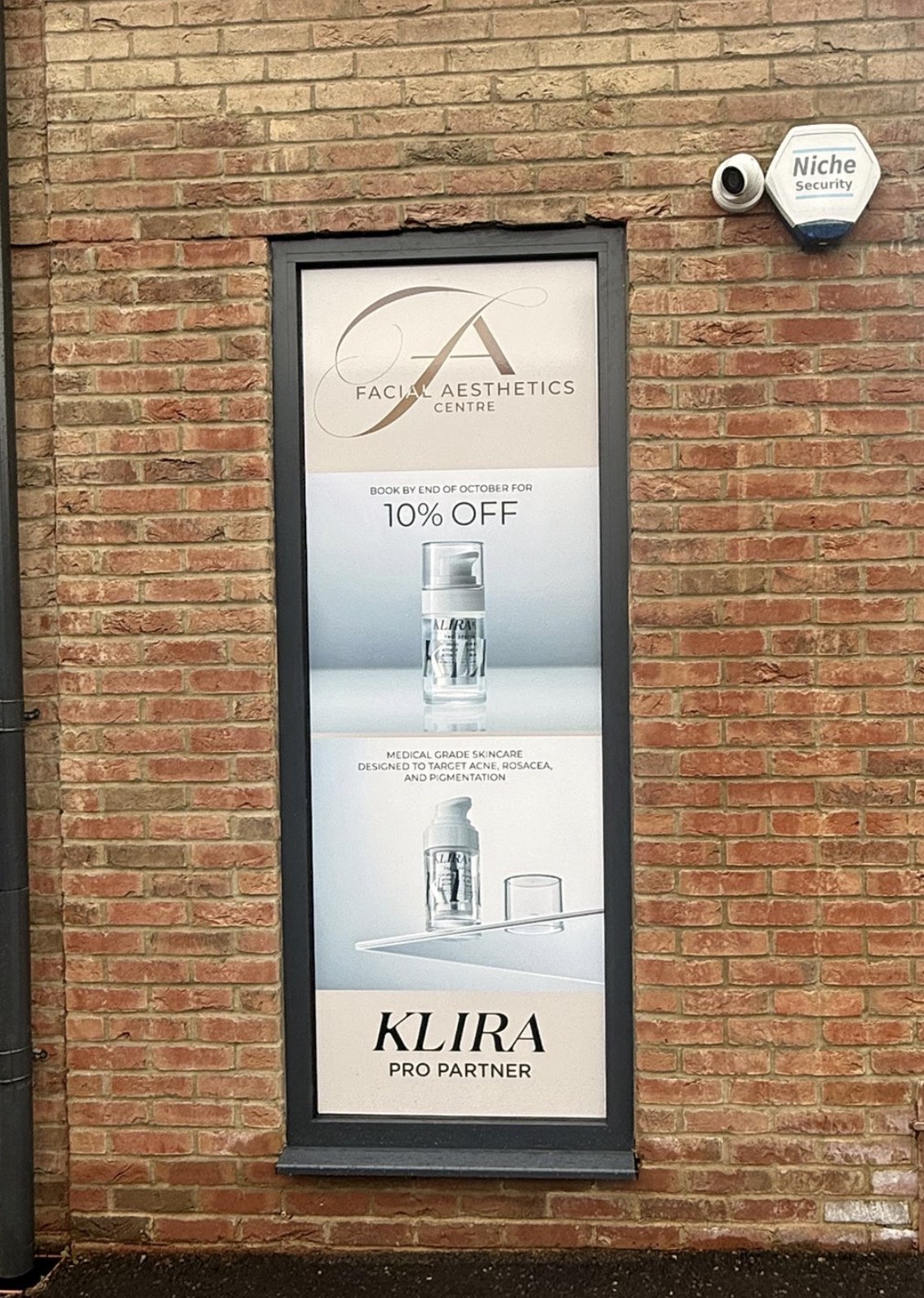 Printed window panel promoting skincare at the Facial Aesthetics Centre.