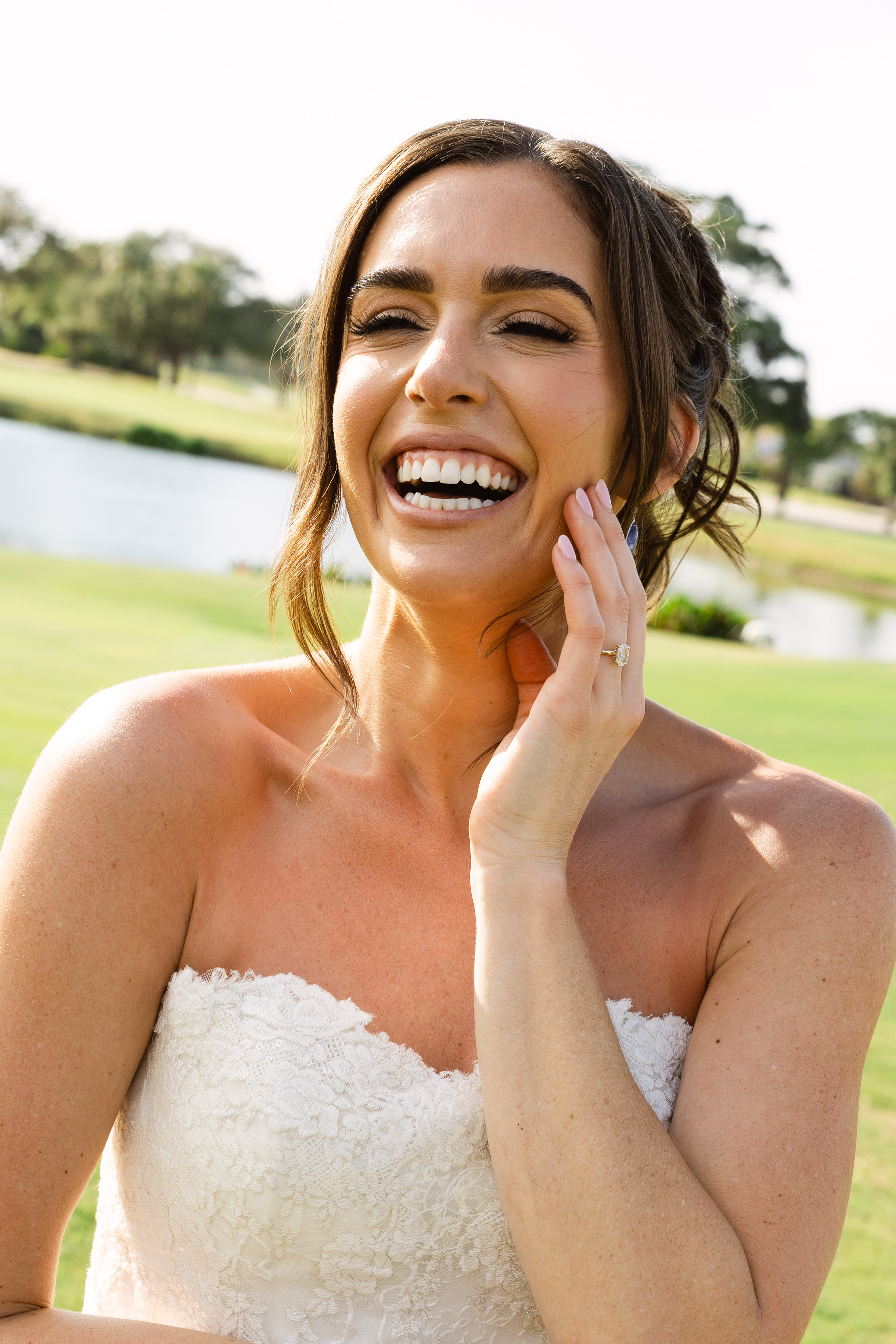 Bride smiling outdoors before her wedding ceremony in Tequesta, Florida.