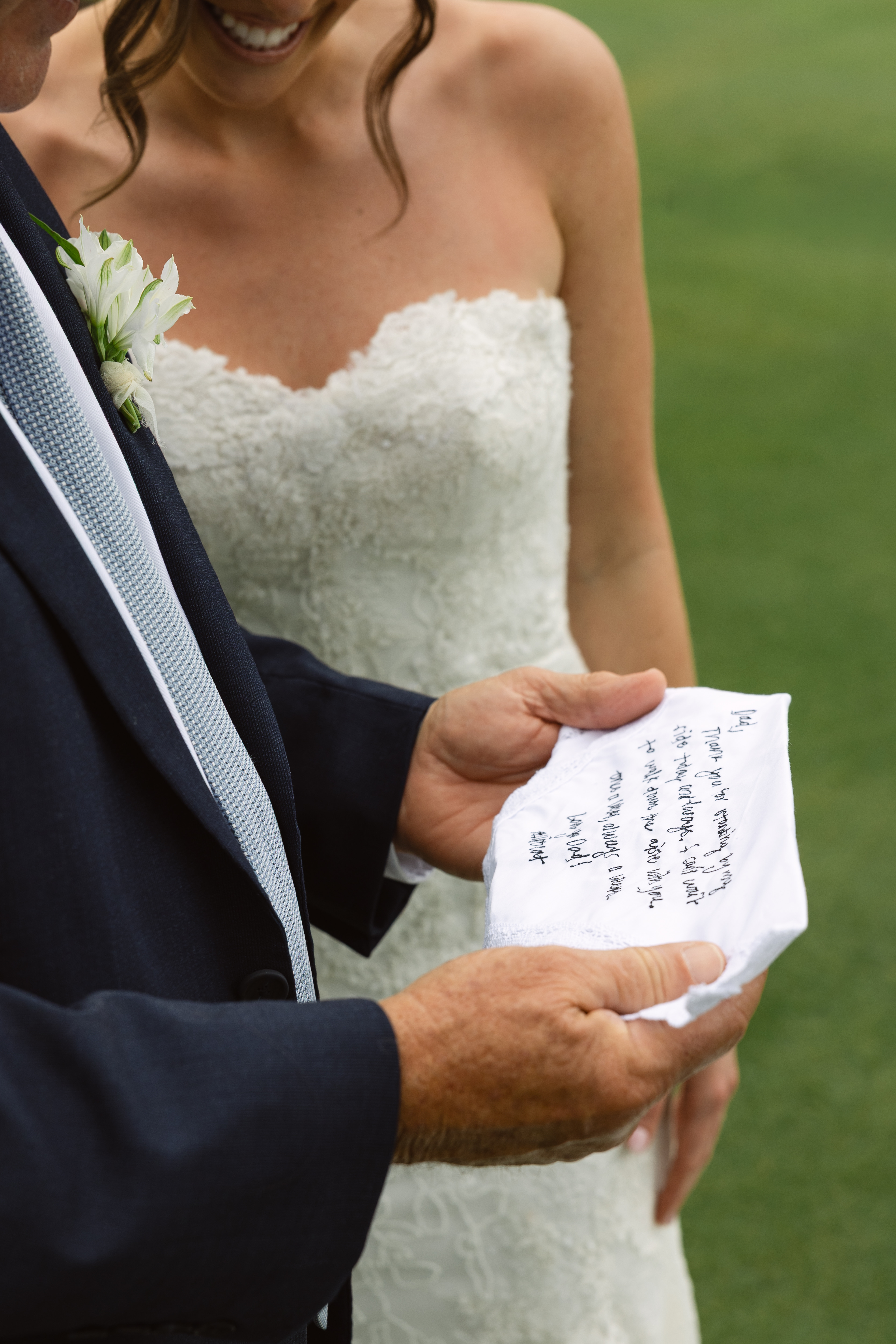 Bride holding a custom wedding-day keepsake featuring a personal message.