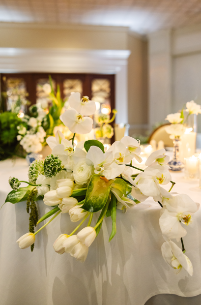 Elegant white and green floral centerpiece displayed during the wedding reception.